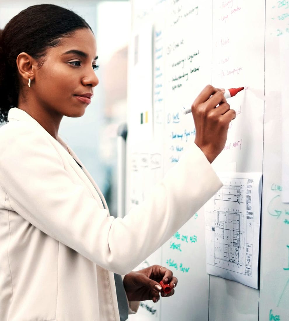 Scientist writing on whiteboard